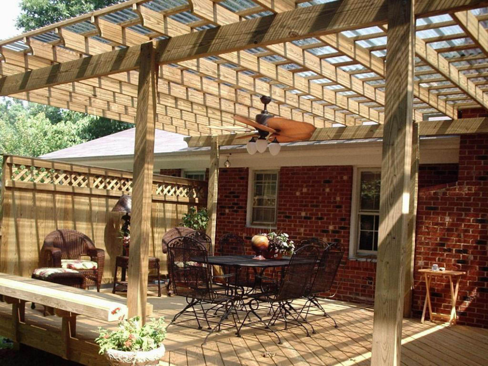 Design ideas for a mid-sized arts and crafts backyard and ground level deck in Other with with privacy feature, a pergola and wood railing.