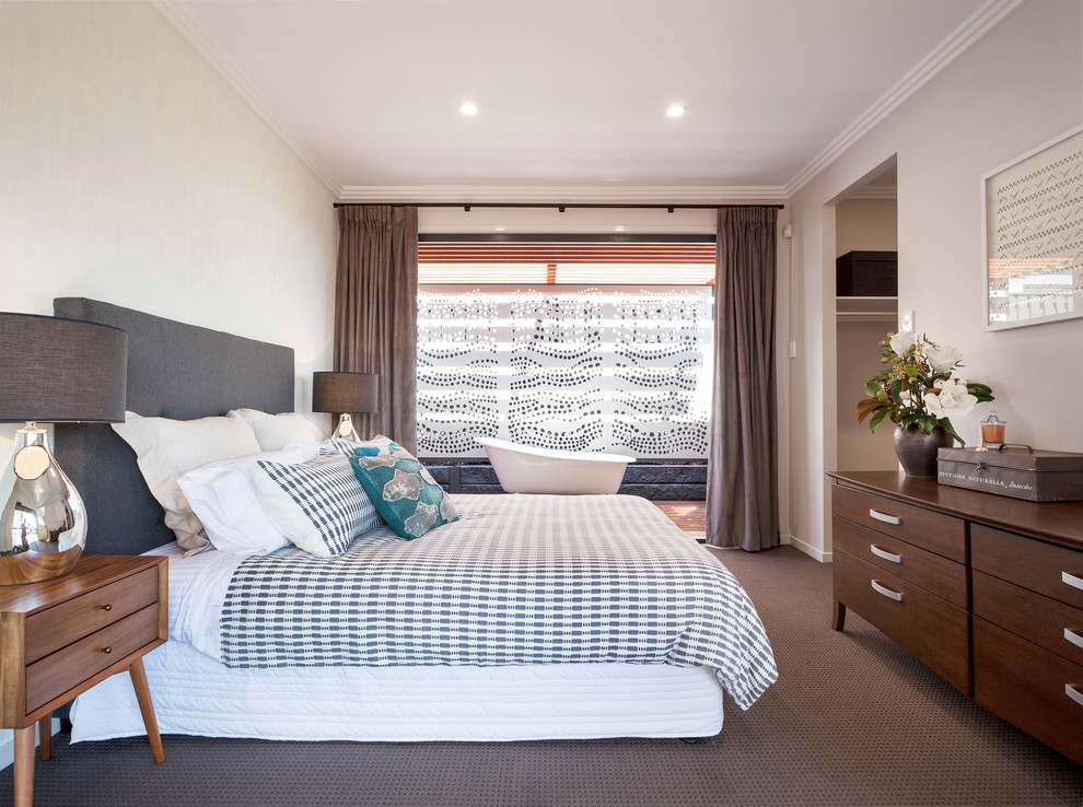 Contemporary bedroom in Brisbane with beige walls and carpet.