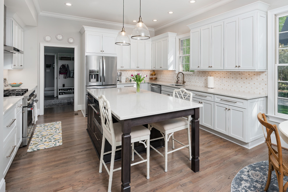 Inspiration for a large transitional u-shaped kitchen remodel in Charlotte with an undermount sink, recessed-panel cabinets, marble countertops, stainless steel appliances and an island
