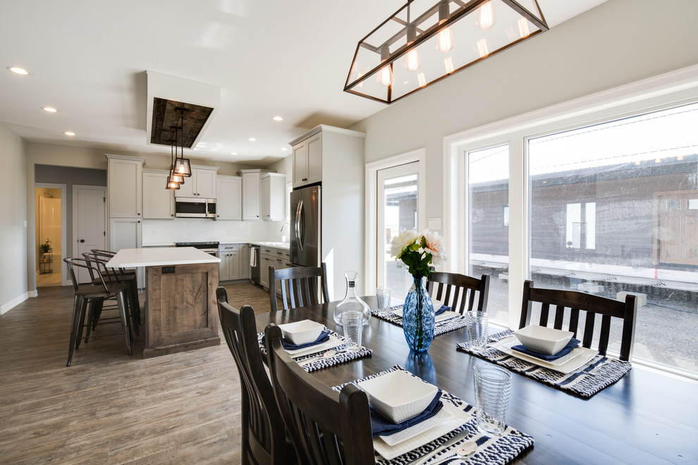 Open concept kitchen - large transitional l-shaped open concept kitchen idea with shaker cabinets, gray cabinets, laminate countertops, stainless steel appliances and an island