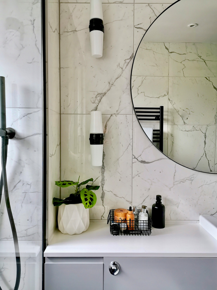 Small contemporary 3/4 bathroom in Other with flat-panel cabinets, grey cabinets, a curbless shower, a one-piece toilet, white tile, ceramic tile, white walls, porcelain floors, an integrated sink, black floor, a sliding shower screen, white benchtops, a single vanity and a built-in vanity.