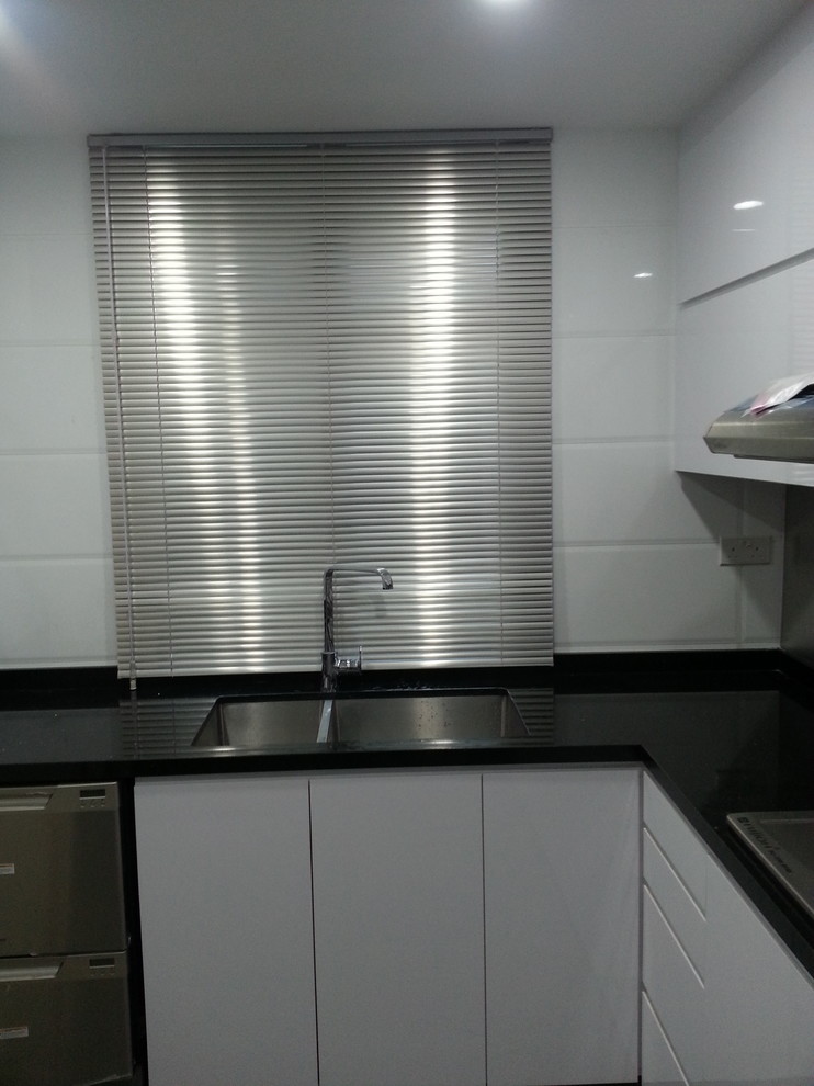Photo of an industrial kitchen in Singapore with stainless steel appliances.