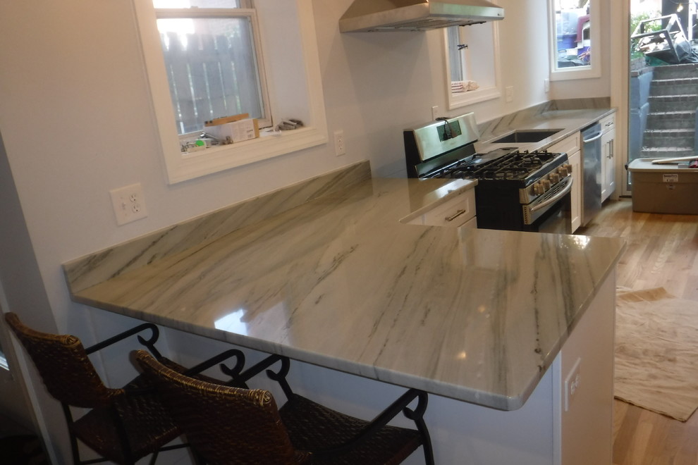 Eat-in kitchen - small transitional single-wall light wood floor eat-in kitchen idea in DC Metro with an undermount sink, shaker cabinets, white cabinets, granite countertops, stone slab backsplash, stainless steel appliances and a peninsula
