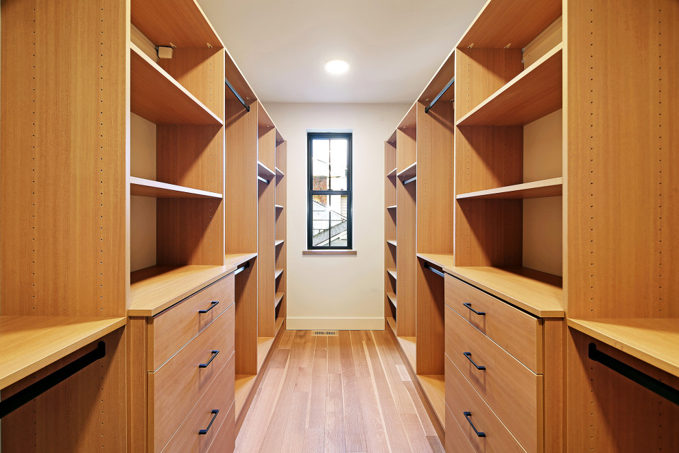 Design ideas for a large scandinavian gender-neutral walk-in wardrobe in Seattle with flat-panel cabinets, medium wood cabinets, medium hardwood floors and brown floor.