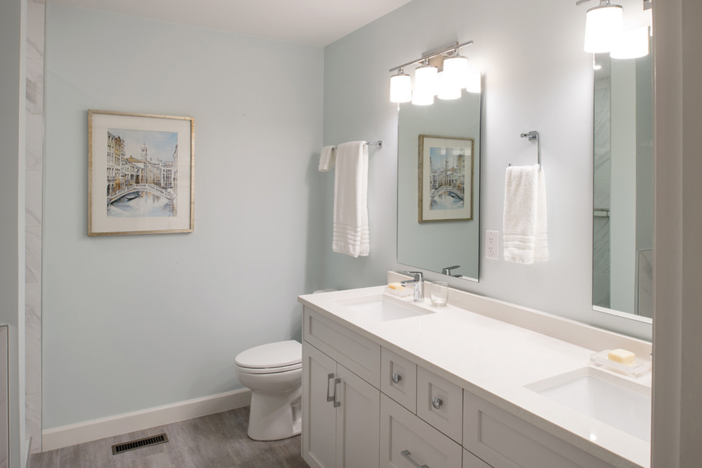 Design ideas for an expansive transitional master bathroom in Vancouver with flat-panel cabinets, dark wood cabinets, a corner shower, a one-piece toilet, gray tile, porcelain tile, blue walls, porcelain floors, an undermount sink and engineered quartz benchtops.