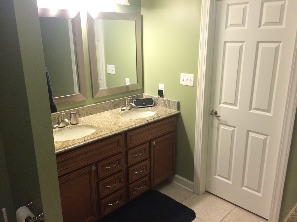 Transitional master ceramic tile bathroom photo with recessed-panel cabinets, medium tone wood cabinets, beige walls and an undermount sink