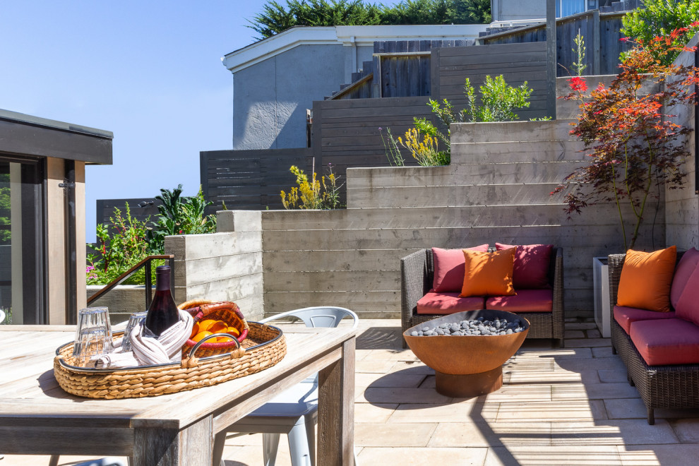 Inspiration for a mid-sized contemporary backyard patio remodel in San Francisco with a fire pit and no cover