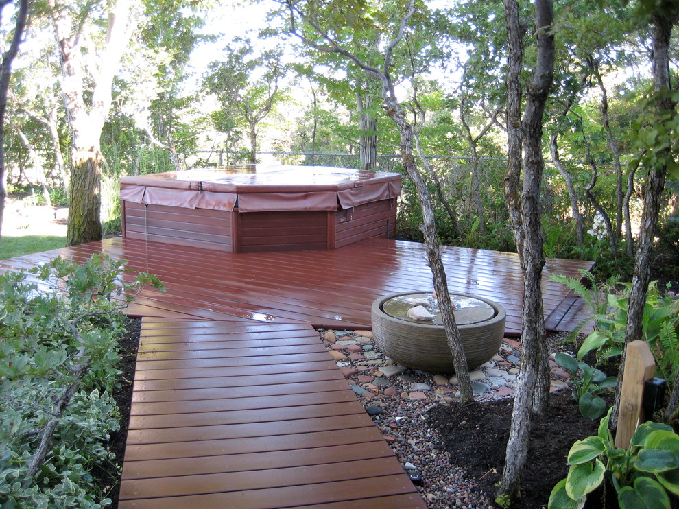 Photo of an expansive contemporary backyard shaded garden for summer in Salt Lake City with a water feature and decking.