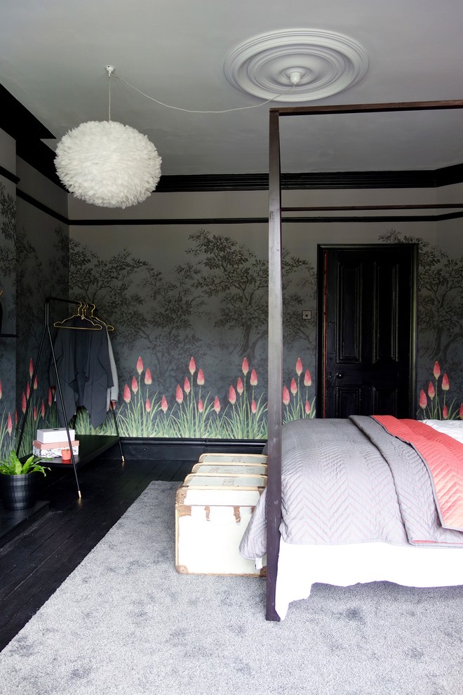 Photo of a mid-sized eclectic guest bedroom in Other with multi-coloured walls, painted wood floors, a standard fireplace, a metal fireplace surround and black floor.