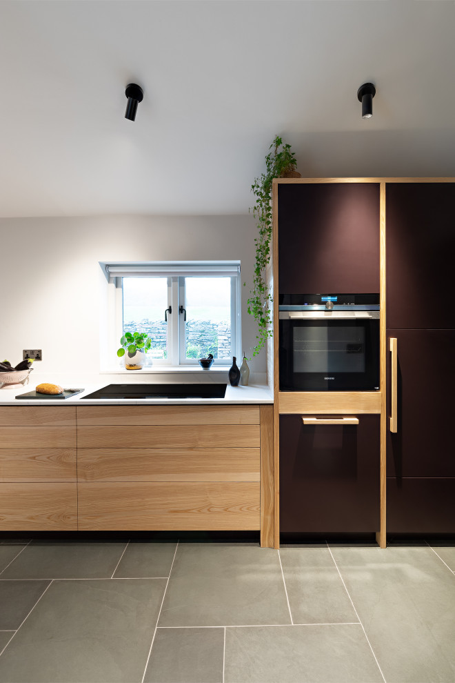 Small contemporary kitchen in Other with solid surface benchtops.