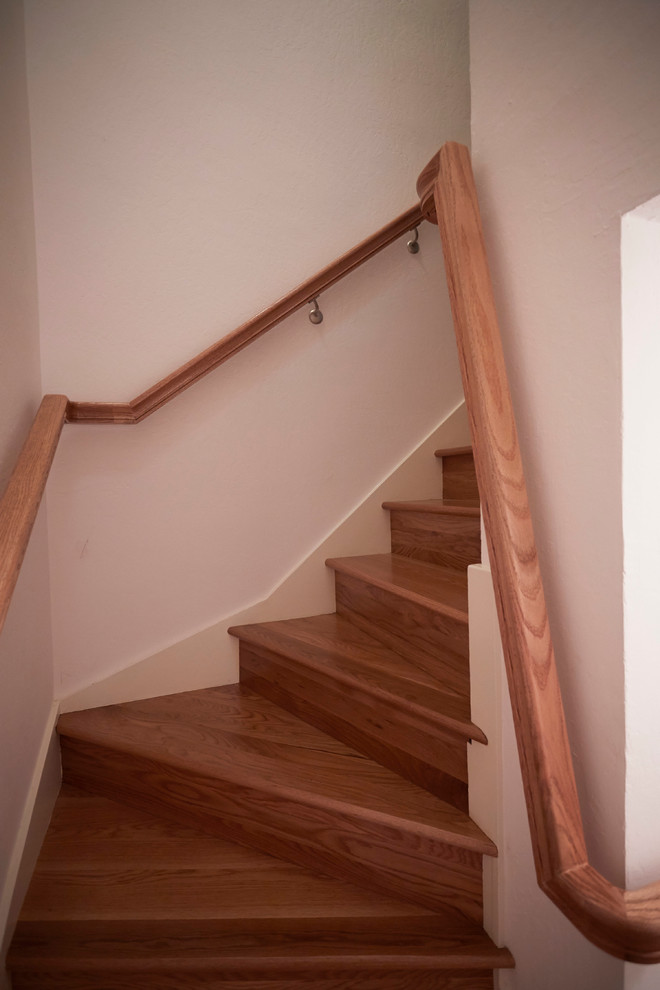 Design ideas for a small traditional wood curved staircase in San Francisco with wood risers.