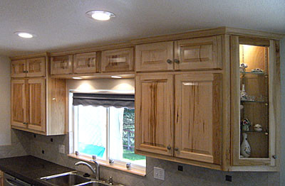 Inspiration for a galley white floor kitchen remodel with raised-panel cabinets, stainless steel appliances, a peninsula and gray countertops
