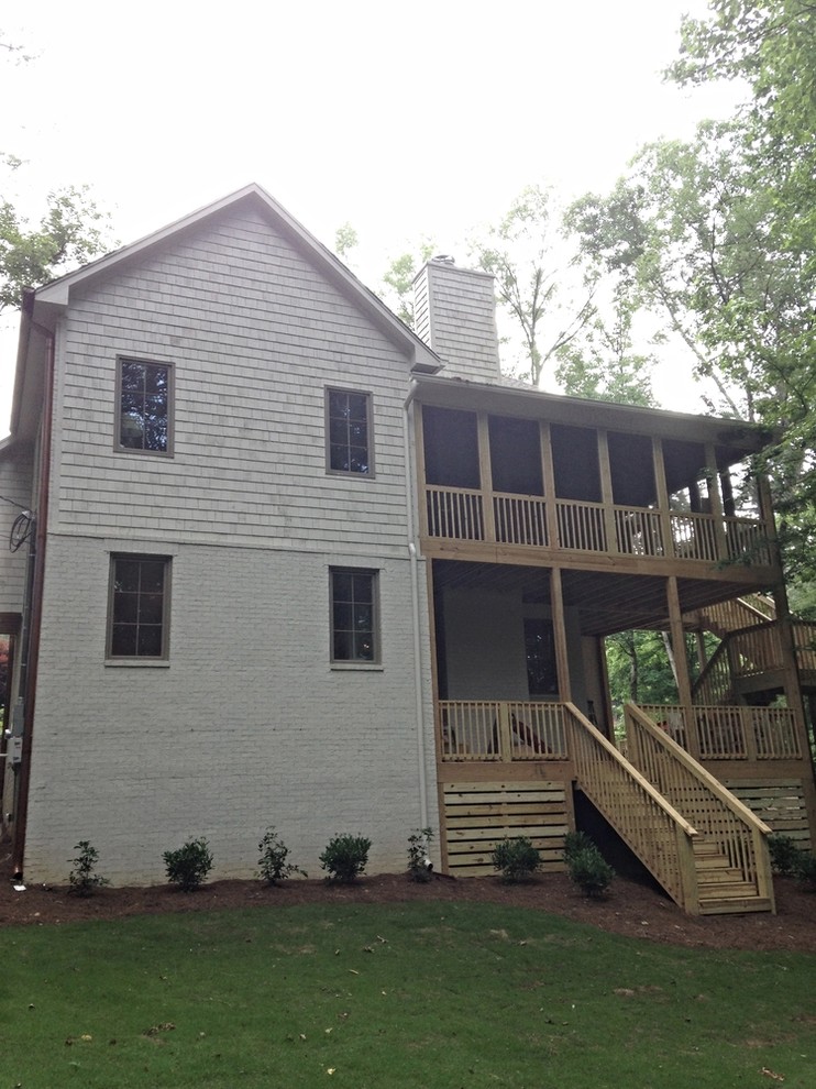 Huge transitional backyard deck photo in Birmingham with a roof extension