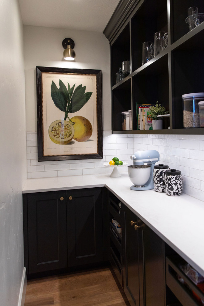 Example of a large transitional medium tone wood floor kitchen design in Seattle with an undermount sink, quartz countertops, white backsplash, subway tile backsplash, stainless steel appliances, an island and white countertops