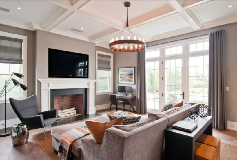 Photo of a large contemporary open concept living room in Toronto with grey walls, medium hardwood floors, a standard fireplace, a wood fireplace surround, a wall-mounted tv and brown floor.