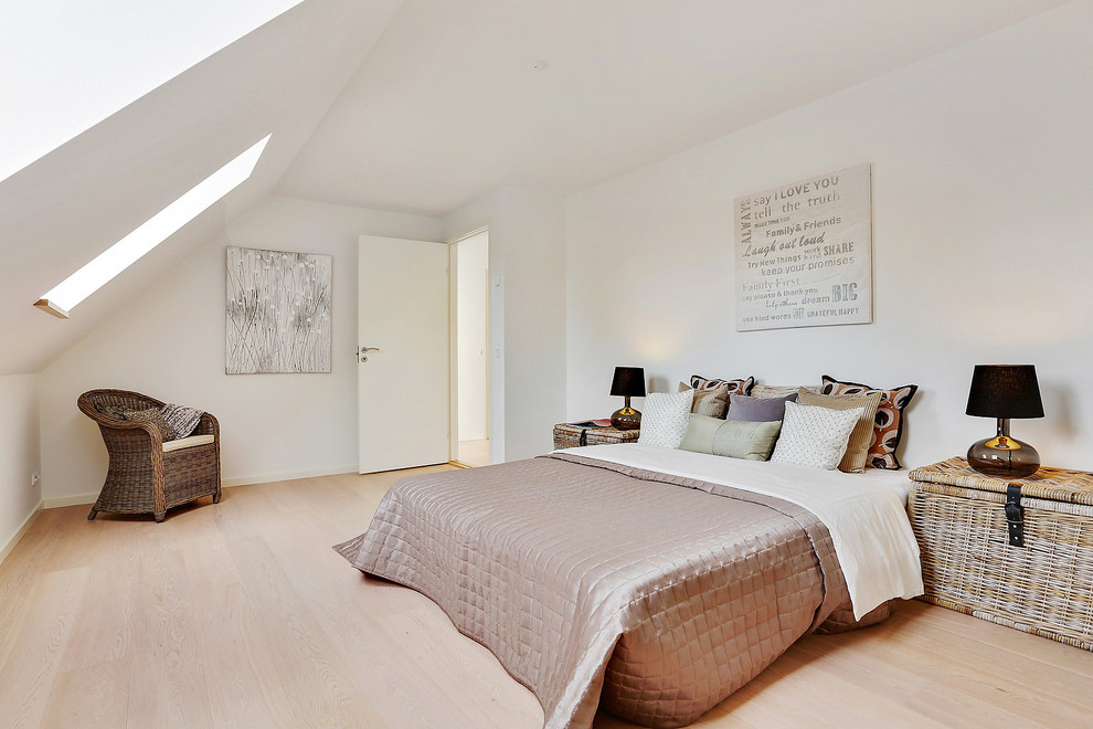 Inspiration for a large scandinavian master bedroom in Copenhagen with white walls, light hardwood floors and no fireplace.