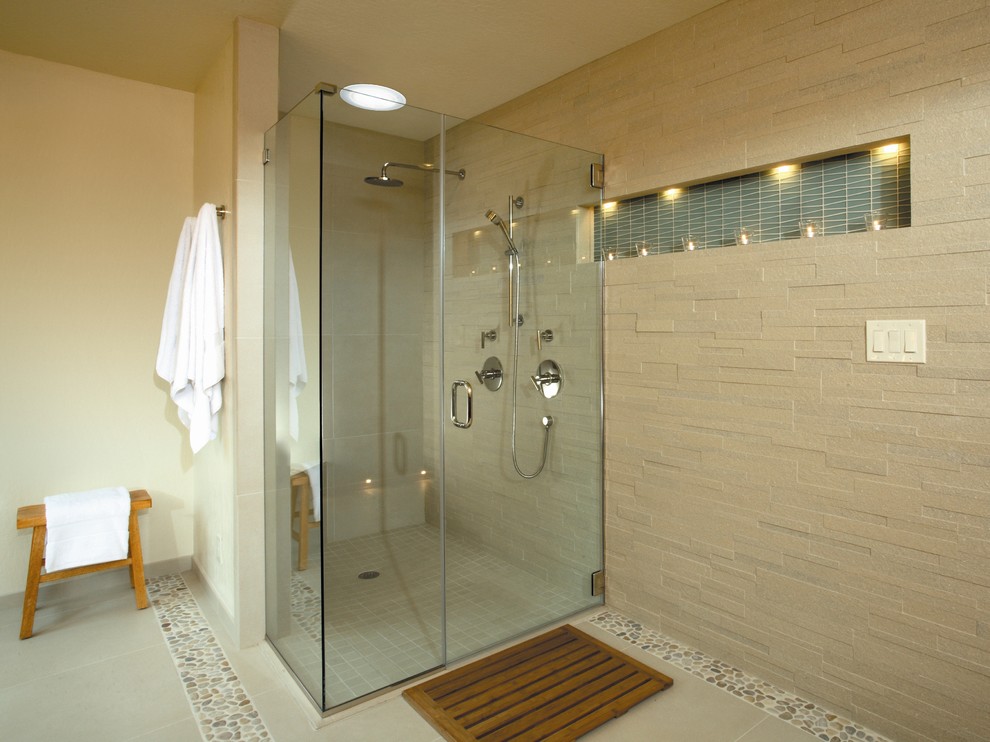This is an example of a mid-sized contemporary master bathroom in Austin with a curbless shower, beige tile, pebble tile, beige walls and pebble tile floors.