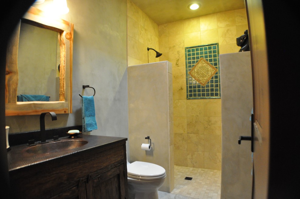 This is an example of a country bathroom in San Diego with a two-piece toilet, black tile, blue tile, gray tile, stone tile, black walls, cement tiles, an integrated sink, shaker cabinets, dark wood cabinets, an open shower and copper benchtops.