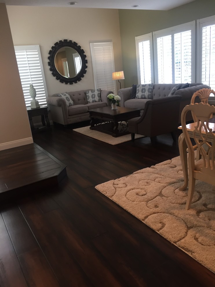 Mid-sized traditional formal open concept living room in Orange County with grey walls, dark hardwood floors, no fireplace, no tv and brown floor.