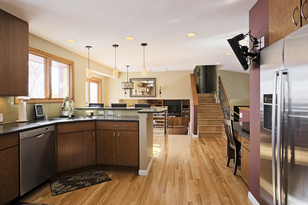 Inspiration for a large light wood floor eat-in kitchen remodel in Minneapolis with an undermount sink, medium tone wood cabinets, beige backsplash and stainless steel appliances