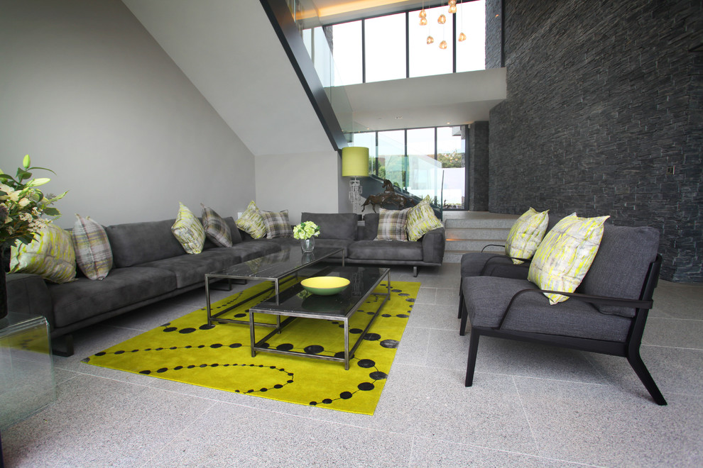 Large contemporary formal open concept living room in Wiltshire with grey walls.