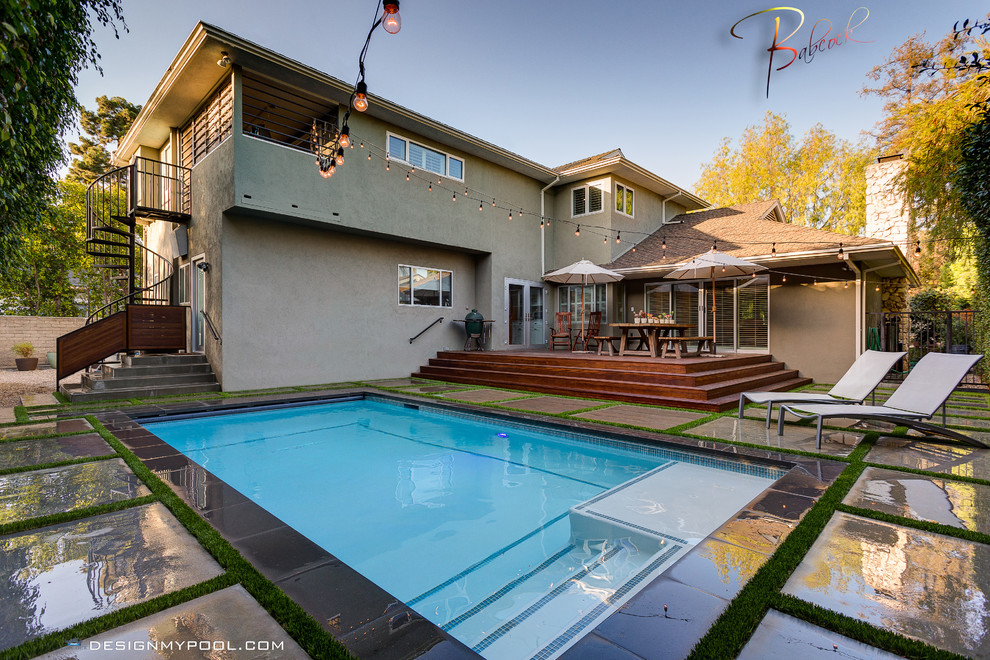 Inspiration for a mid-sized modern backyard concrete and rectangular privacy pool remodel in Los Angeles