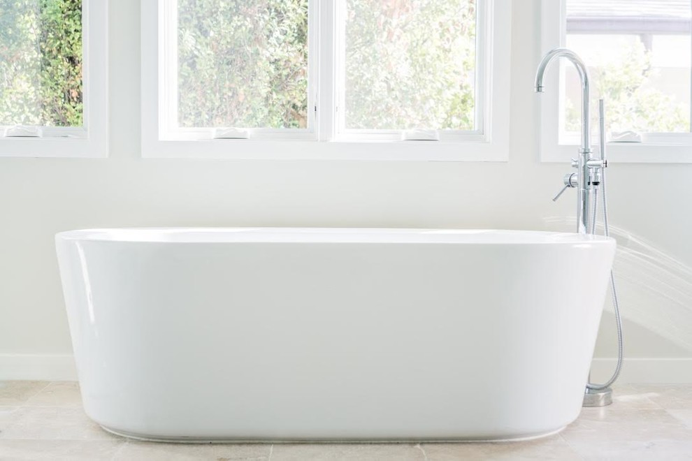 Inspiration for a mid-sized transitional master gray tile and marble tile ceramic tile and beige floor freestanding bathtub remodel in Orange County with shaker cabinets, white cabinets, gray walls, a drop-in sink, marble countertops, a hinged shower door and white countertops