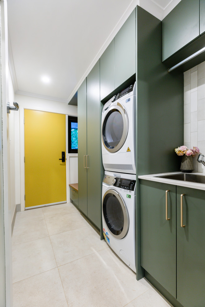 Design ideas for a small eclectic galley dedicated laundry room in Canberra - Queanbeyan with an undermount sink, flat-panel cabinets, green cabinets, quartz benchtops, grey splashback, ceramic splashback, white walls, ceramic floors, grey floor and white benchtop.