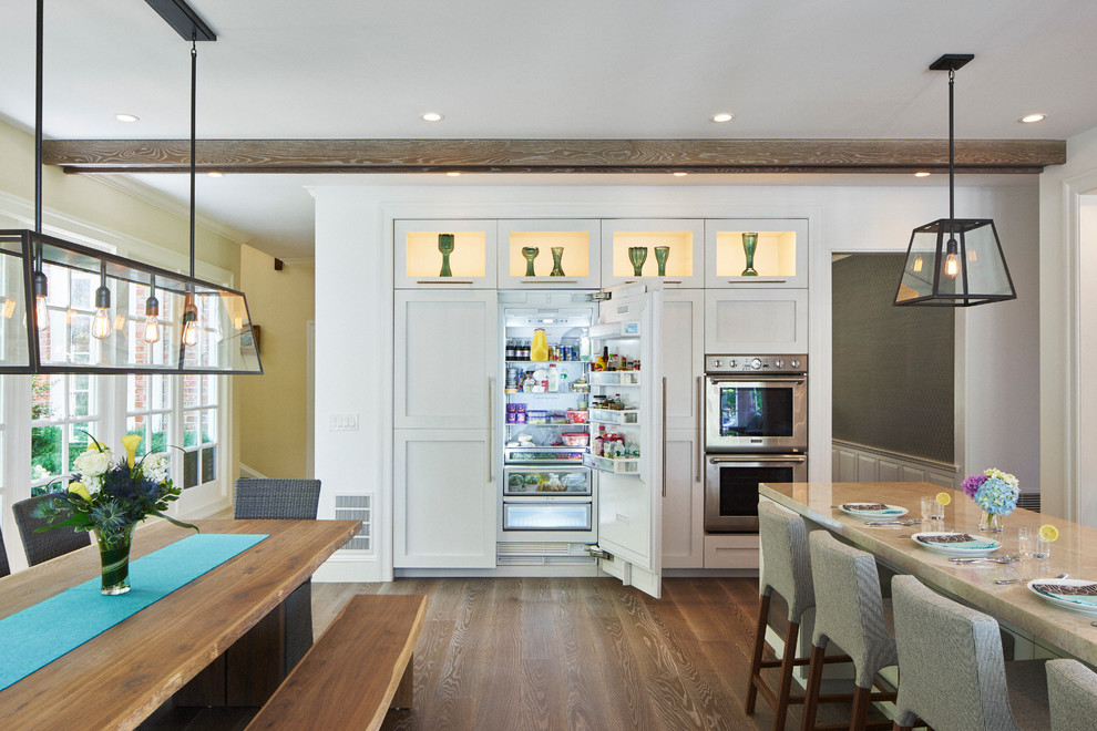 Inspiration for a large transitional l-shaped eat-in kitchen in New York with an undermount sink, shaker cabinets, white cabinets, quartzite benchtops, grey splashback, stone slab splashback, stainless steel appliances, medium hardwood floors and with island.