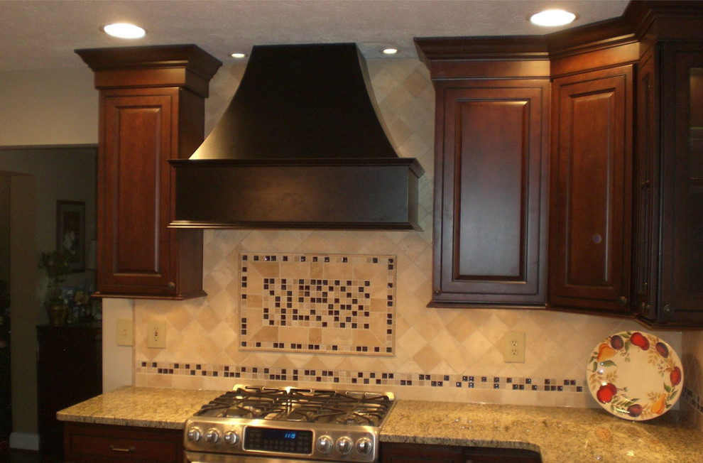 Kitchen - large transitional kitchen idea in Baltimore with shaker cabinets, dark wood cabinets, granite countertops, beige backsplash, stone tile backsplash and stainless steel appliances