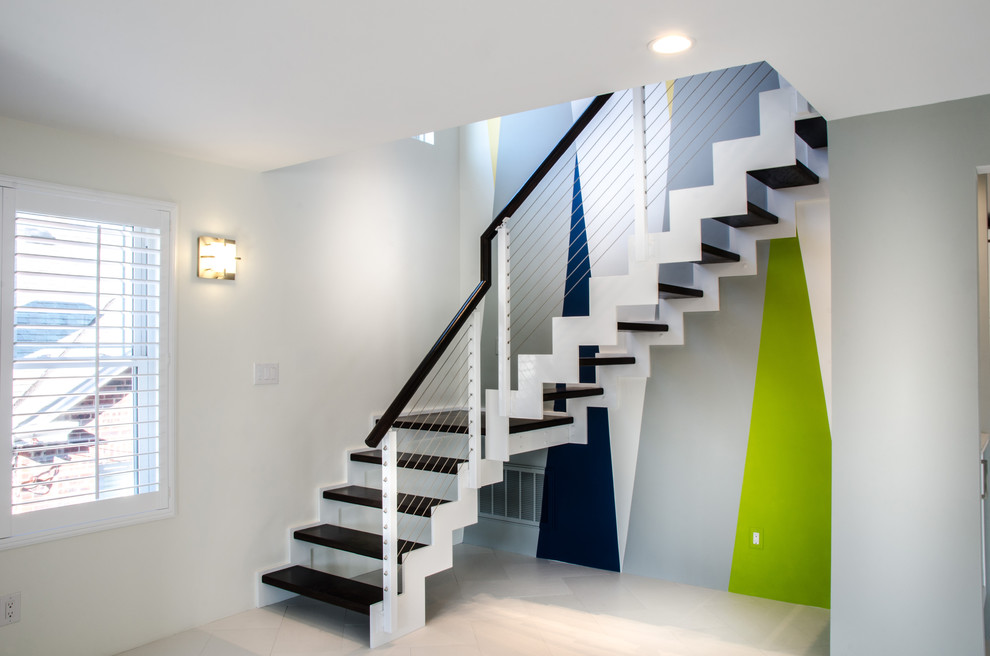 Inspiration for a mid-sized contemporary wood curved staircase in Philadelphia with wood risers.