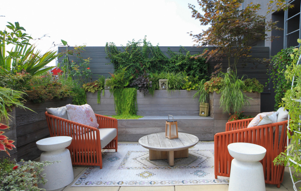 Photo of a medium sized modern roof rooftop wood railing terrace in New York with a potted garden and no cover.
