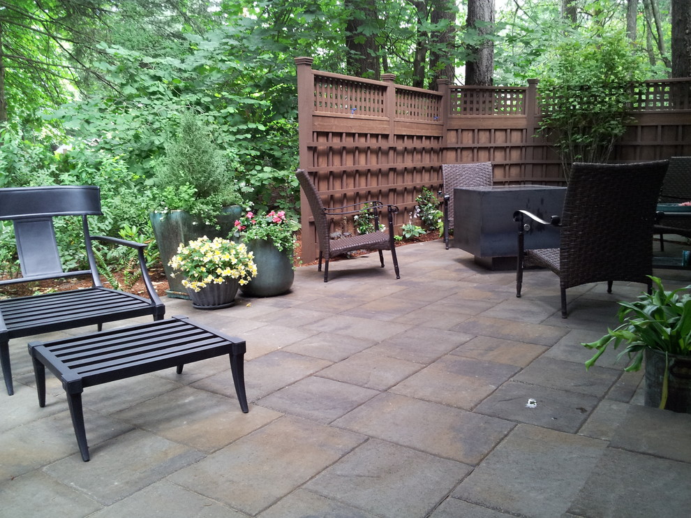 Design ideas for a mid-sized arts and crafts backyard patio in Portland with a fire feature, natural stone pavers and no cover.