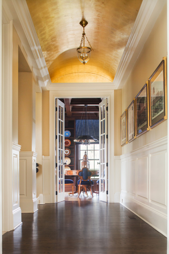 Photo of a large traditional hallway in New York with beige walls and dark hardwood floors.