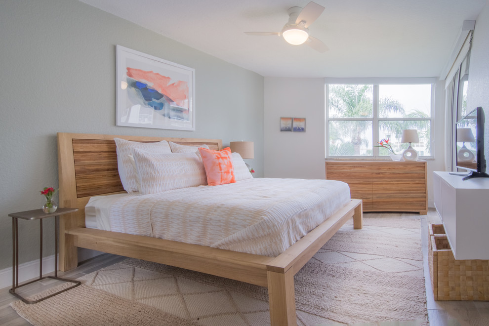 Inspiration for a mid-sized beach style master bedroom in Tampa with porcelain floors.