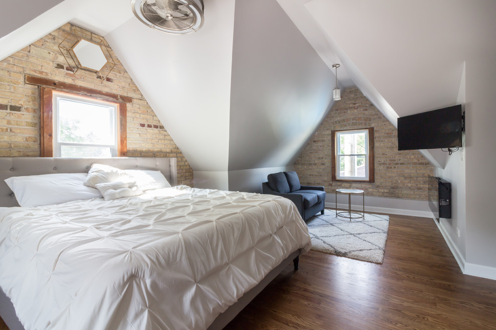 Transitional master bedroom in Boston with grey walls, medium hardwood floors, a hanging fireplace and brown floor.