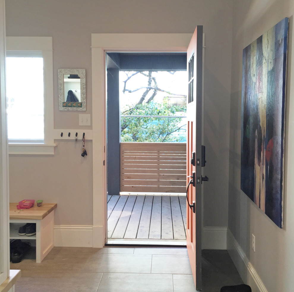 Inspiration for a large transitional porcelain tile and beige floor mudroom remodel with gray walls and an orange front door