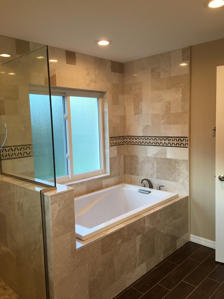 Design ideas for a mid-sized transitional master bathroom in Tampa with a drop-in tub, an alcove shower, beige tile, travertine, beige walls, vinyl floors, brown floor and a hinged shower door.