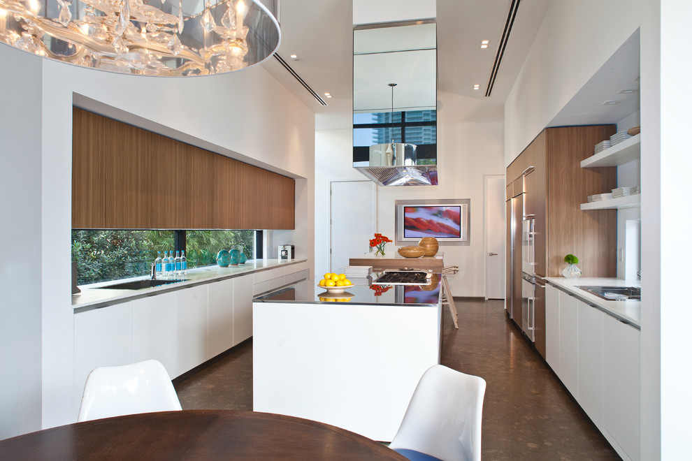Design ideas for a contemporary galley eat-in kitchen in Miami with flat-panel cabinets, white cabinets and with island.