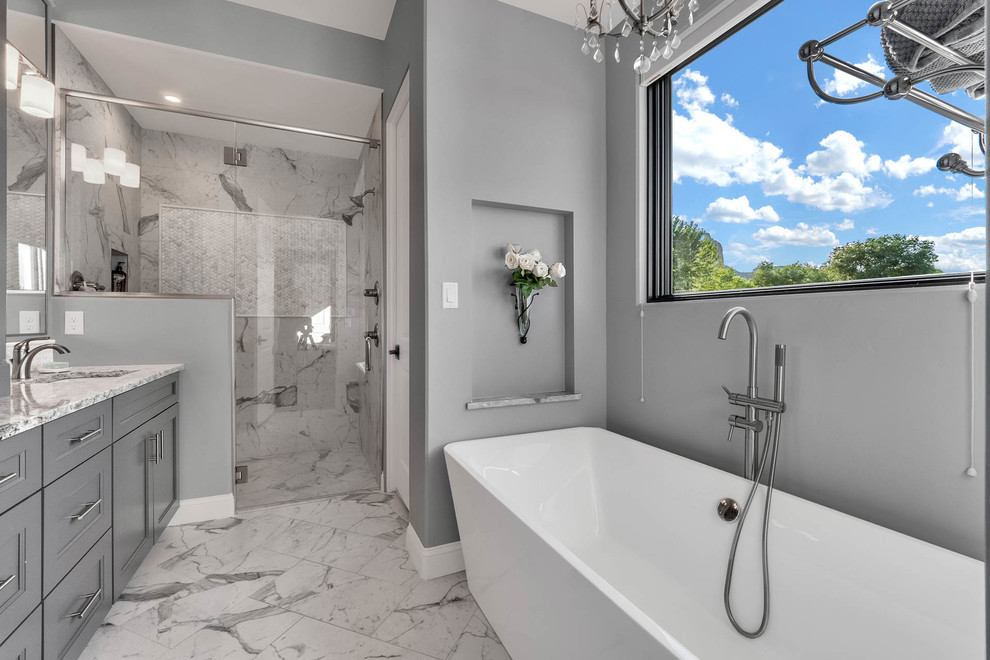 Country bathroom in Denver with furniture-like cabinets, grey cabinets, a freestanding tub, a curbless shower, porcelain tile, grey walls, porcelain floors, an undermount sink, engineered quartz benchtops, multi-coloured floor and a hinged shower door.