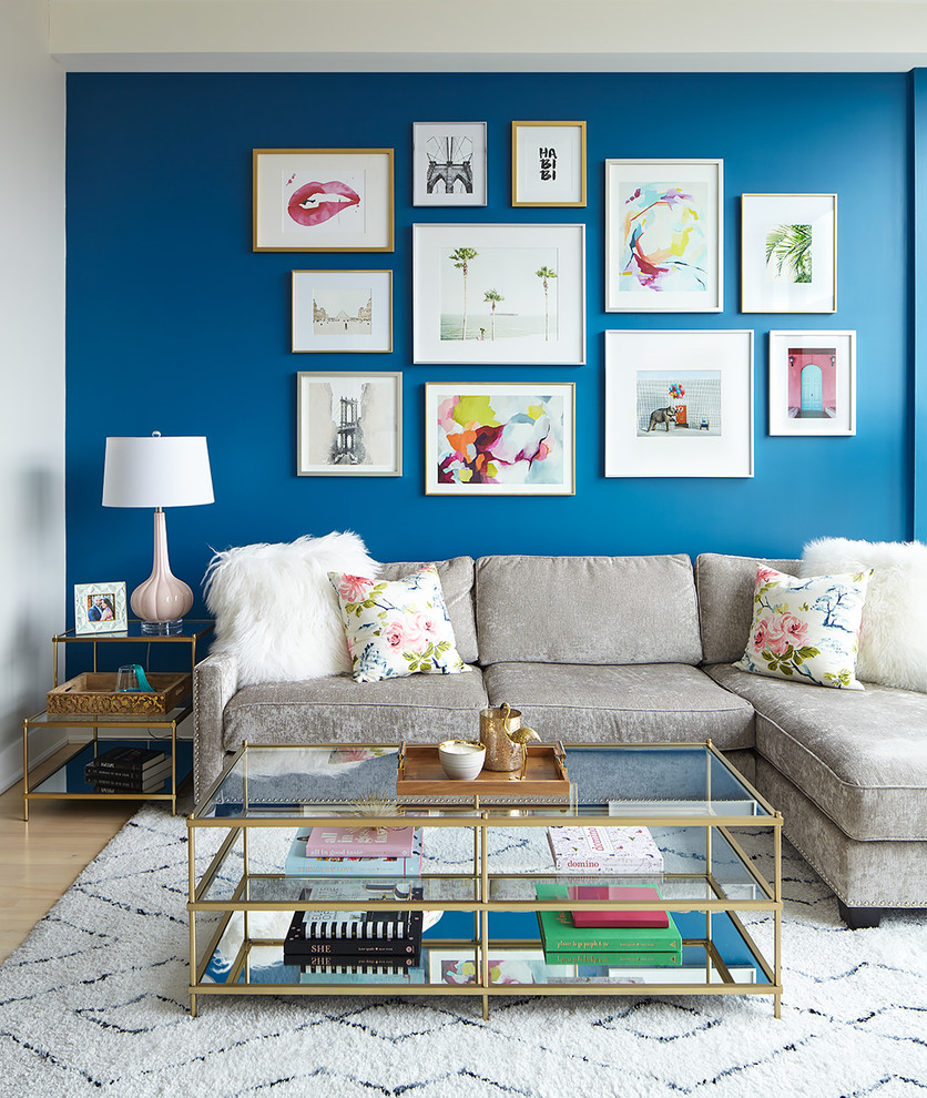 Design ideas for a transitional living room in Toronto with blue walls, light hardwood floors and beige floor.