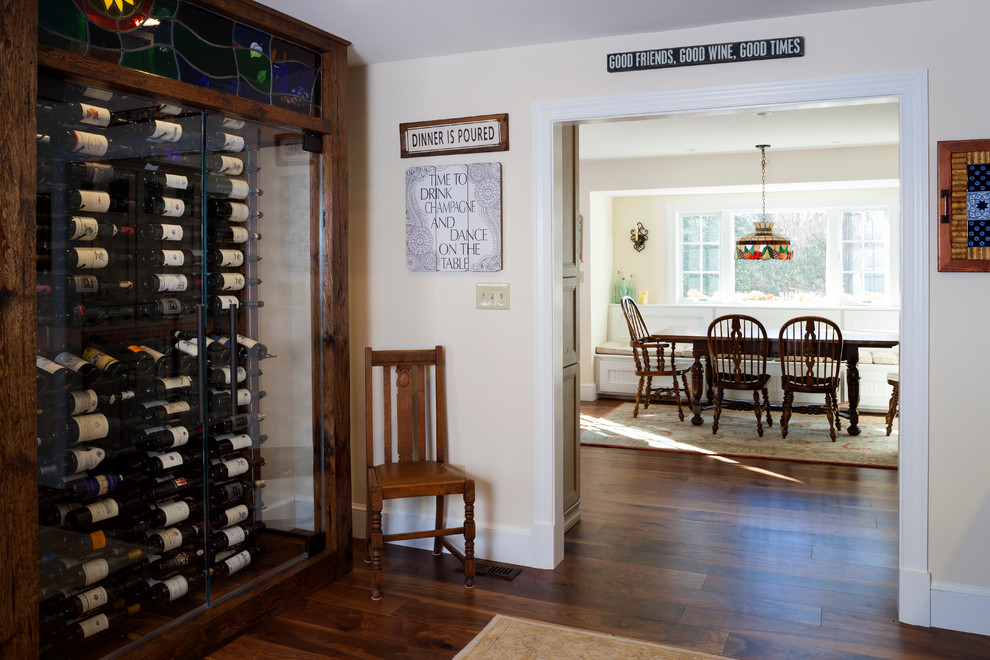 Inspiration for a mid-sized traditional wine cellar in DC Metro with dark hardwood floors, storage racks and brown floor.