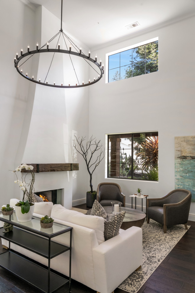 Large modern formal open concept living room in Other with white walls, dark hardwood floors, a standard fireplace, a plaster fireplace surround, a wall-mounted tv and beige floor.