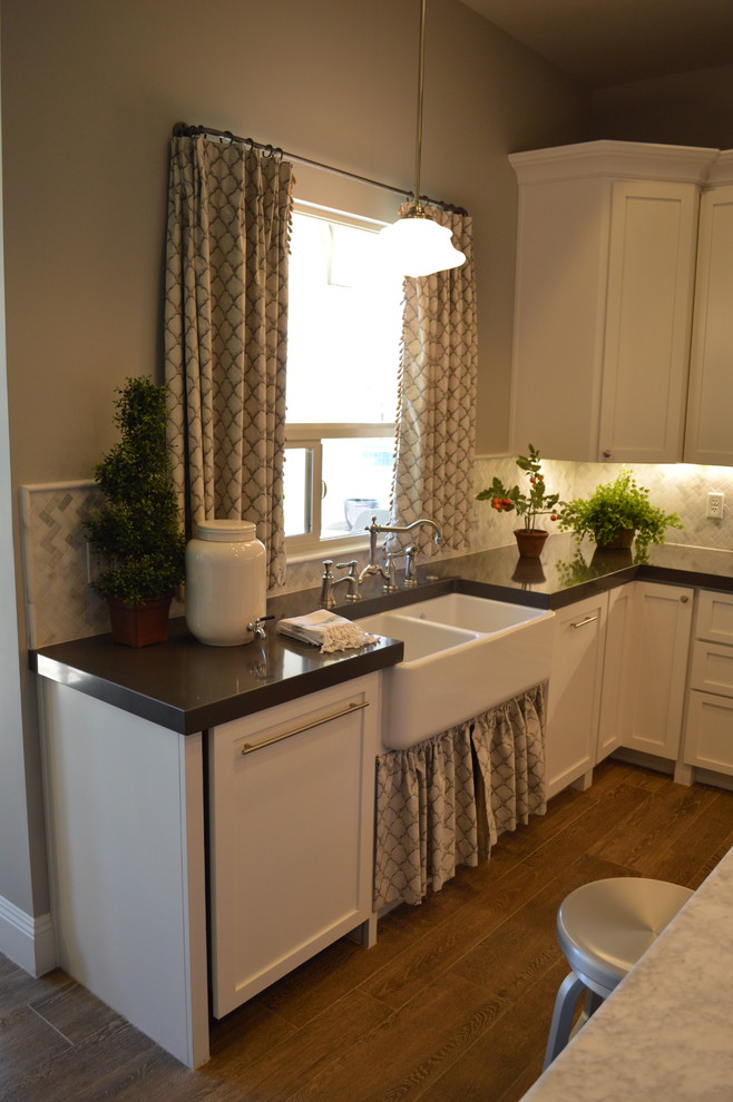 Kitchen - large transitional u-shaped porcelain tile kitchen idea in Phoenix with a farmhouse sink, shaker cabinets, white cabinets, quartz countertops, gray backsplash, mosaic tile backsplash, paneled appliances and an island