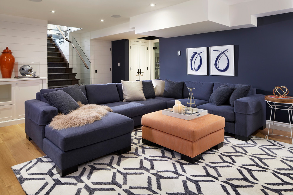 Photo of a mid-sized contemporary fully buried basement in Toronto with blue walls, light hardwood floors and beige floor.