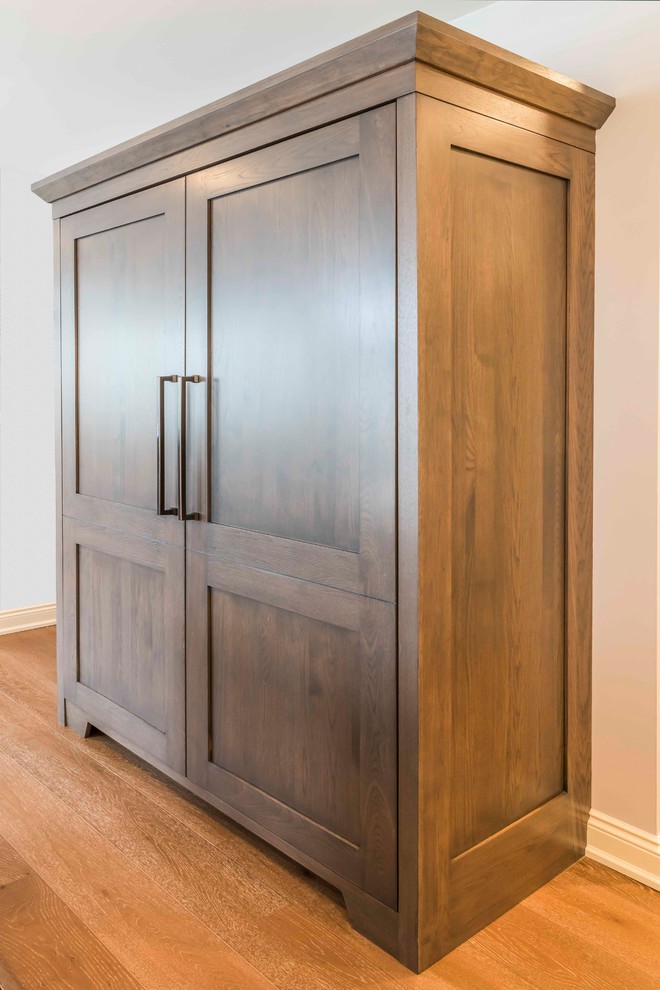 Mid-sized transitional u-shaped medium tone wood floor and brown floor home design photo in Calgary with an undermount sink, marble countertops, gray backsplash, ceramic backsplash, paneled appliances, an island, shaker cabinets and brown cabinets