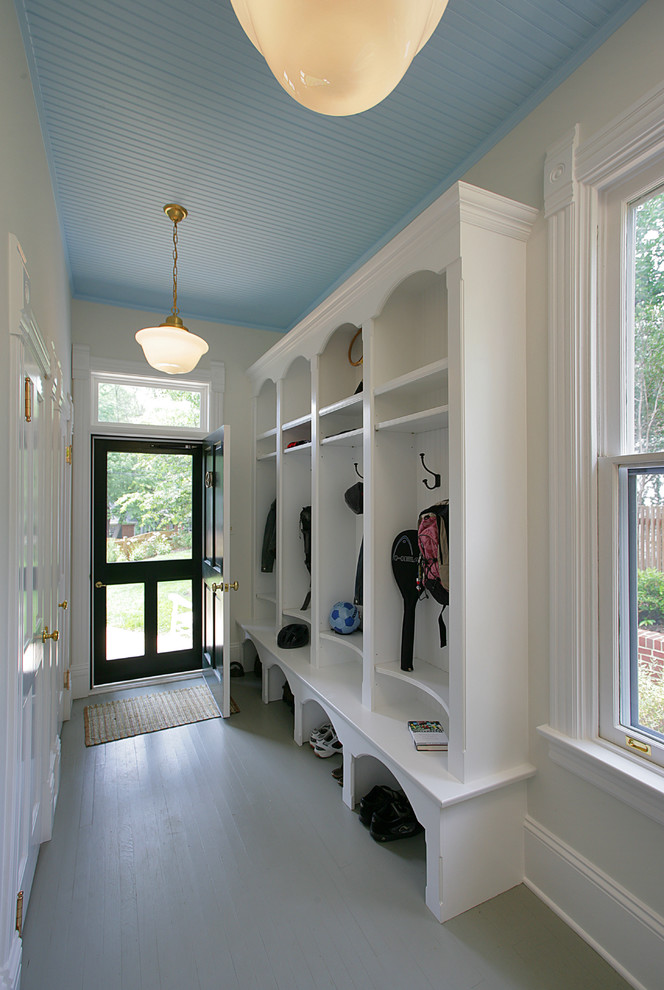 Photo of a traditional mudroom in DC Metro with painted wood floors.