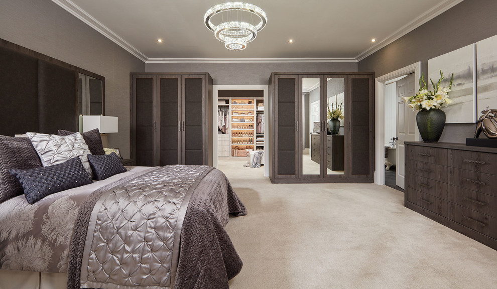 Inspiration for a large contemporary master bedroom in Manchester with beige walls, carpet and beige floor.