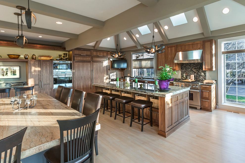 Huge transitional u-shaped light wood floor eat-in kitchen photo in Chicago with an undermount sink, recessed-panel cabinets, medium tone wood cabinets, granite countertops, green backsplash, stone slab backsplash, stainless steel appliances and an island