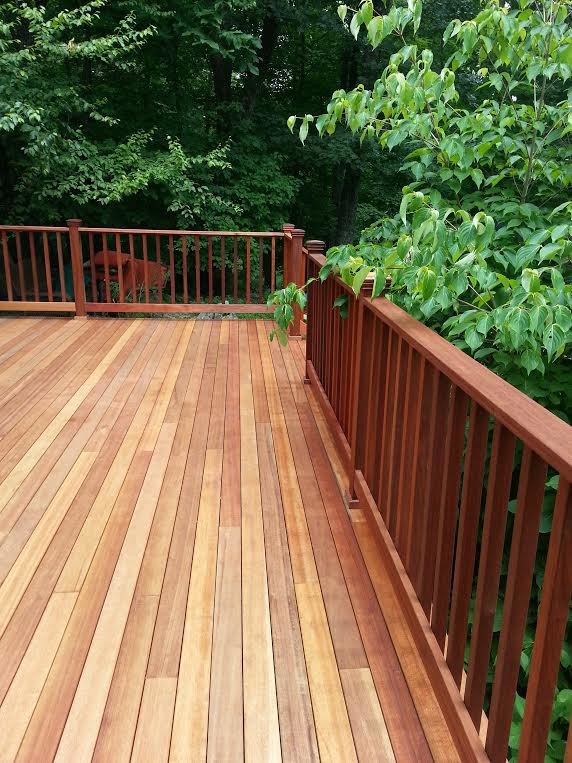 This is an example of a large traditional backyard deck in New York with no cover.